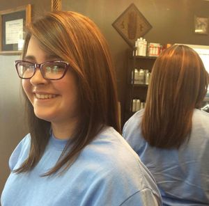 Before and after view of a sleek shoulder-length haircut with side-swept bangs and glasses in a salon setting.