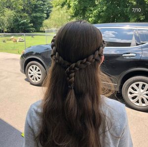 Braided dark hair style shown from behind with multiple small braids woven together in a casual pattern.