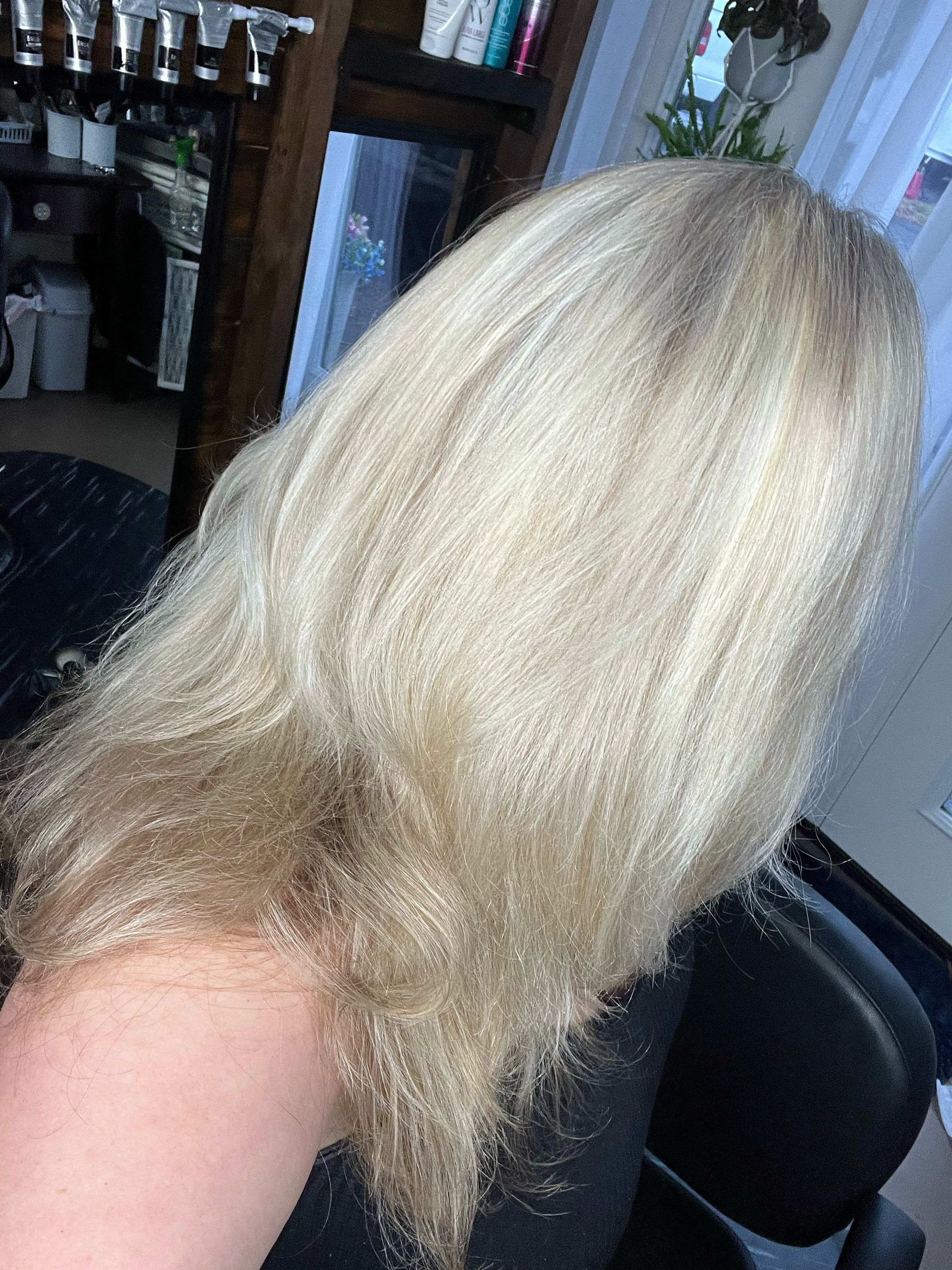 A series of photos showing blonde hair at different angles in a salon setting.