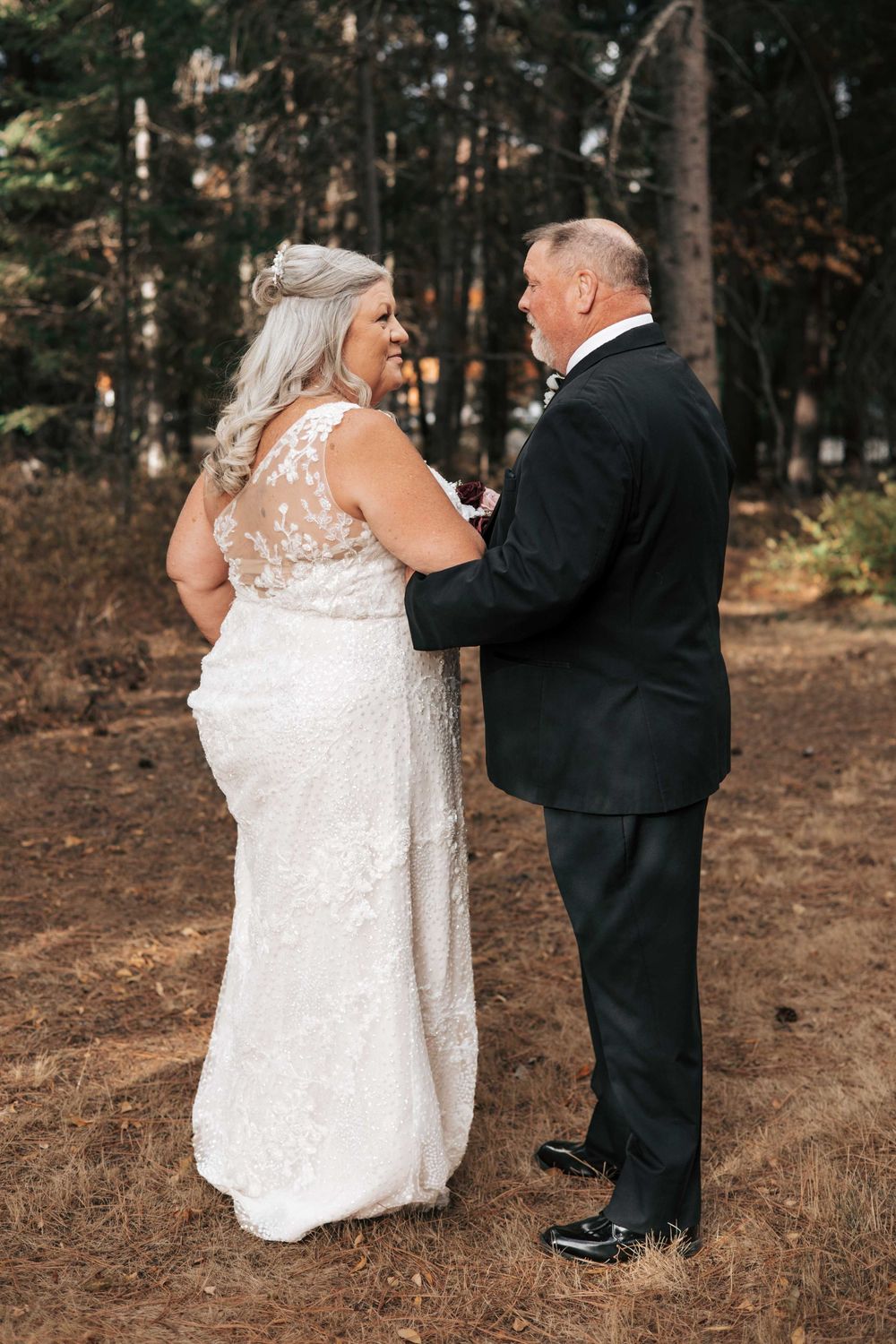 Suncadia, WA wedding couple looking at each other with trees in the background.