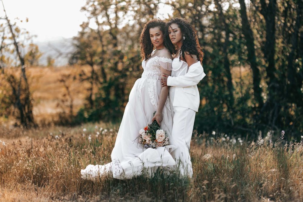 Ellensburg, WA wedding couple walking on tall brown grassy scene with Columbia River in the background.