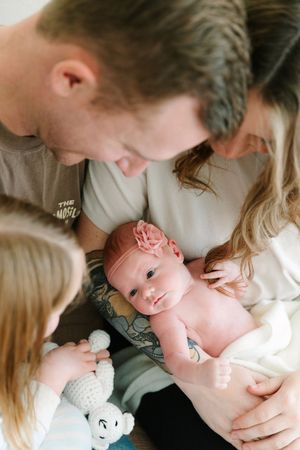 A series of intimate family moments showing parents cradling and bonding with their newborn baby.
