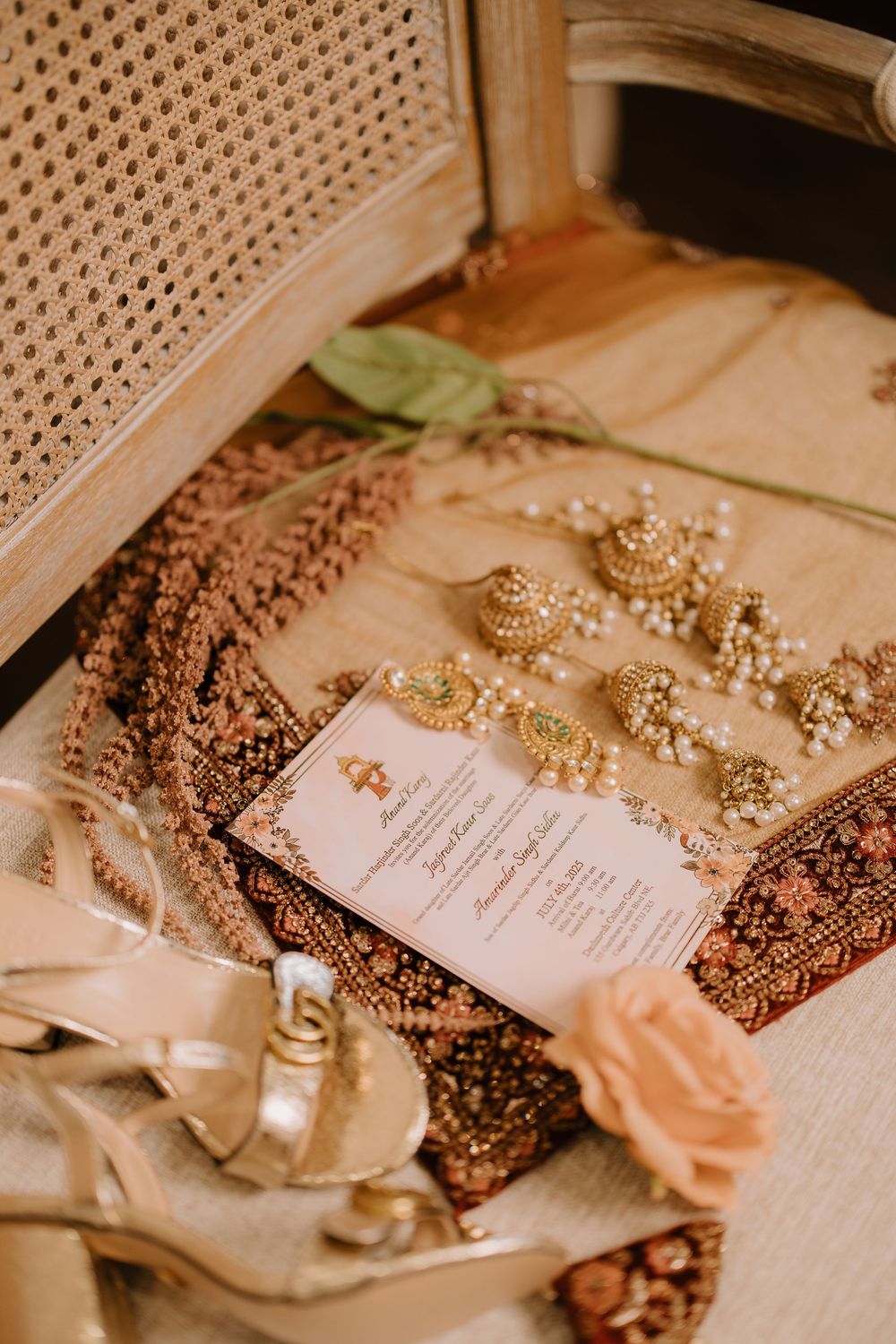 Elegant wedding invitation details with lace and pearls on a cream-colored surface.