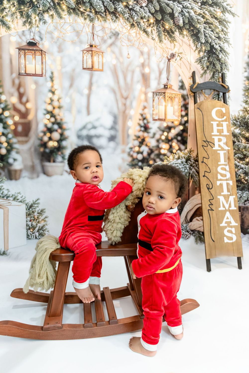 Four festive holiday photos show a red velvet outfit against a snowy winter backdrop with wooden Christmas decorations.