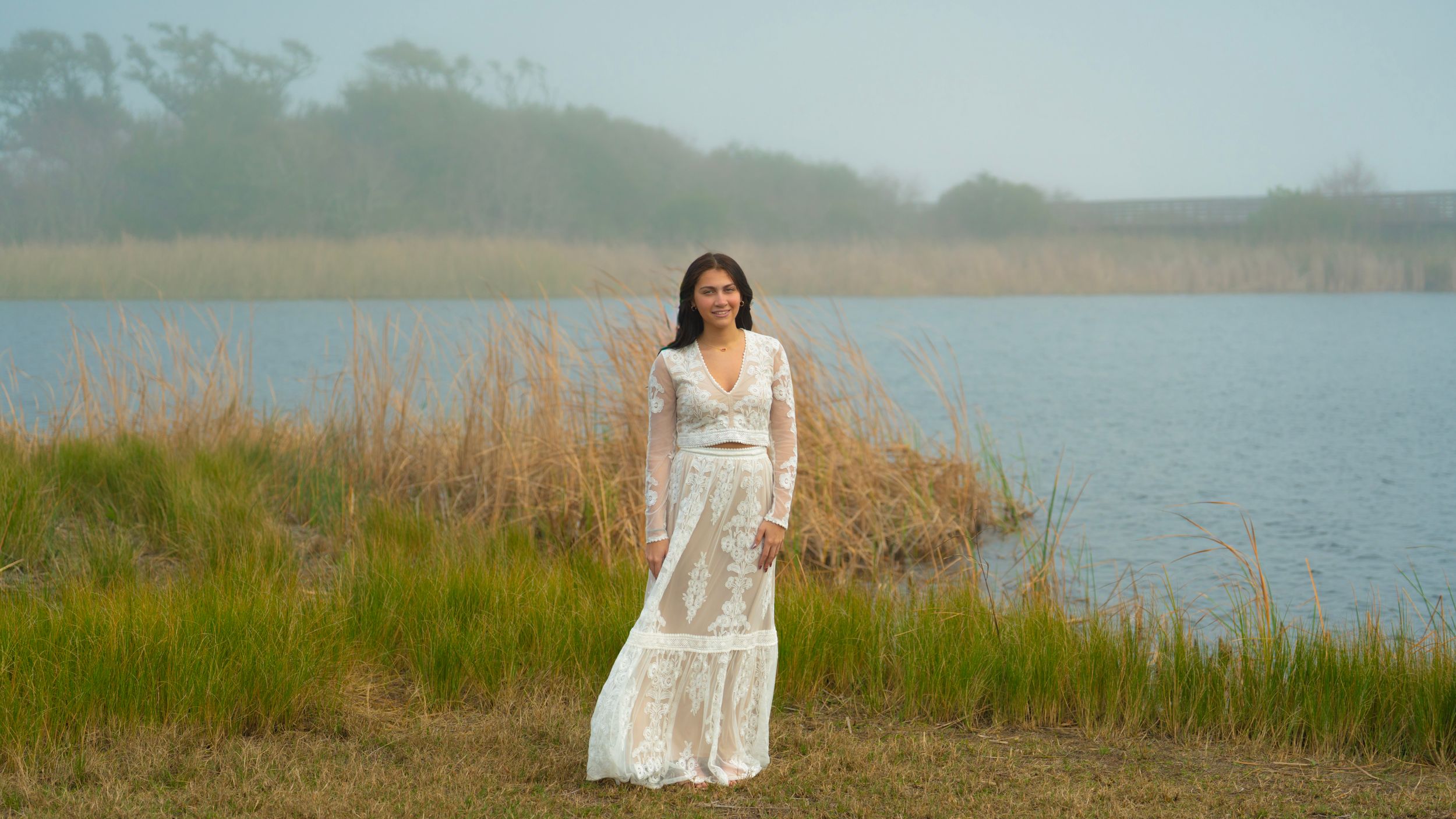 Scenic coastal landscape with marsh grass and water at golden hour.