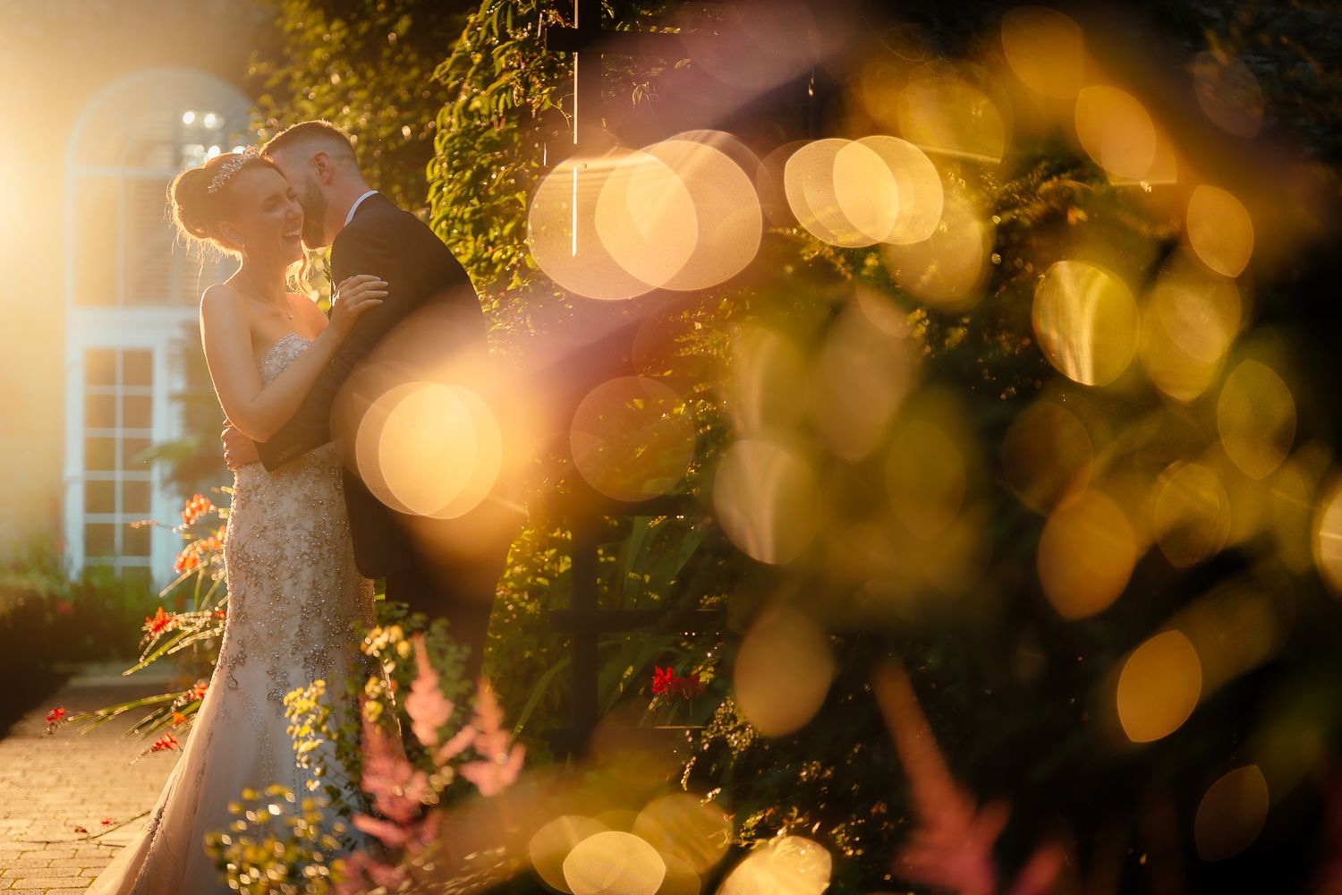 Romantic golden hour scene with bokeh lights and garden setting. Woodhill Hall.