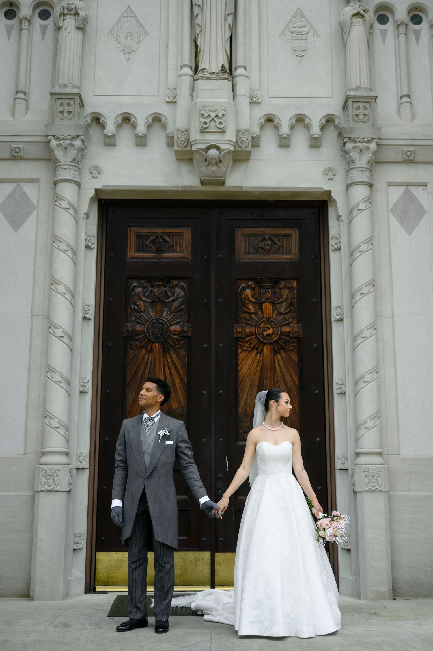 A happy couple shares joyful moments together on their wedding day, with the bride in white and groom in black suit.
