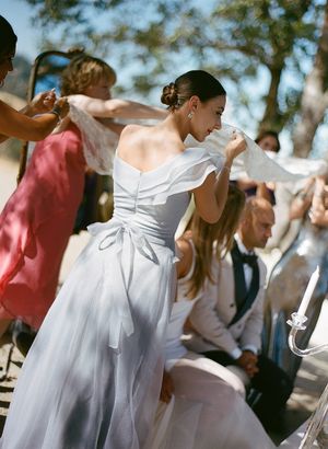 Lively dancing at an outdoor wedding celebration with guests in formal attire.