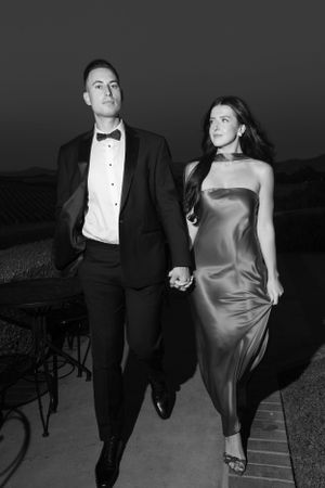 Dramatic black and white portrait of couple in formal evening attire.