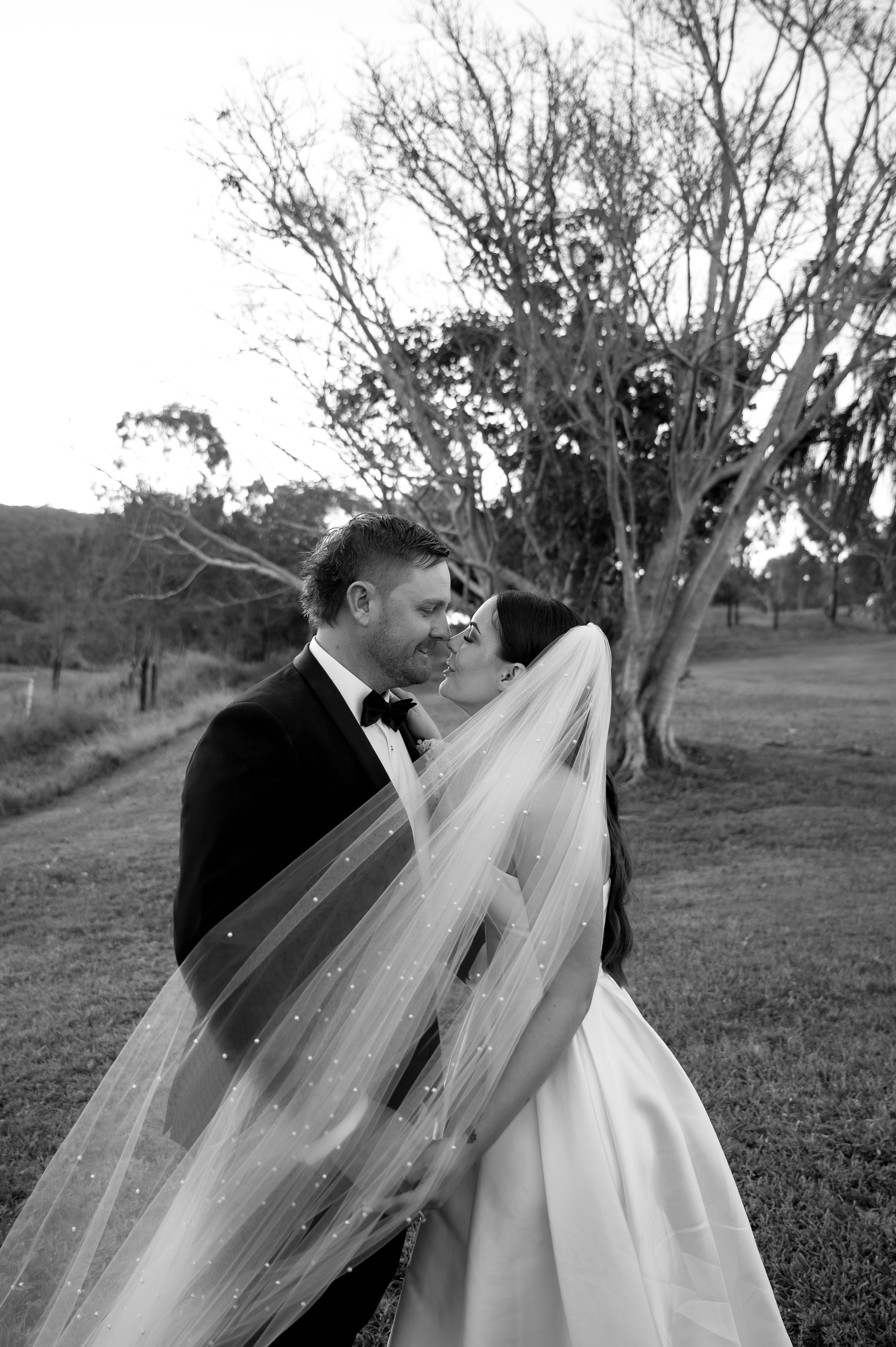 A black and white wedding photo sequence shows a couple embracing under trees in a romantic outdoor setting.