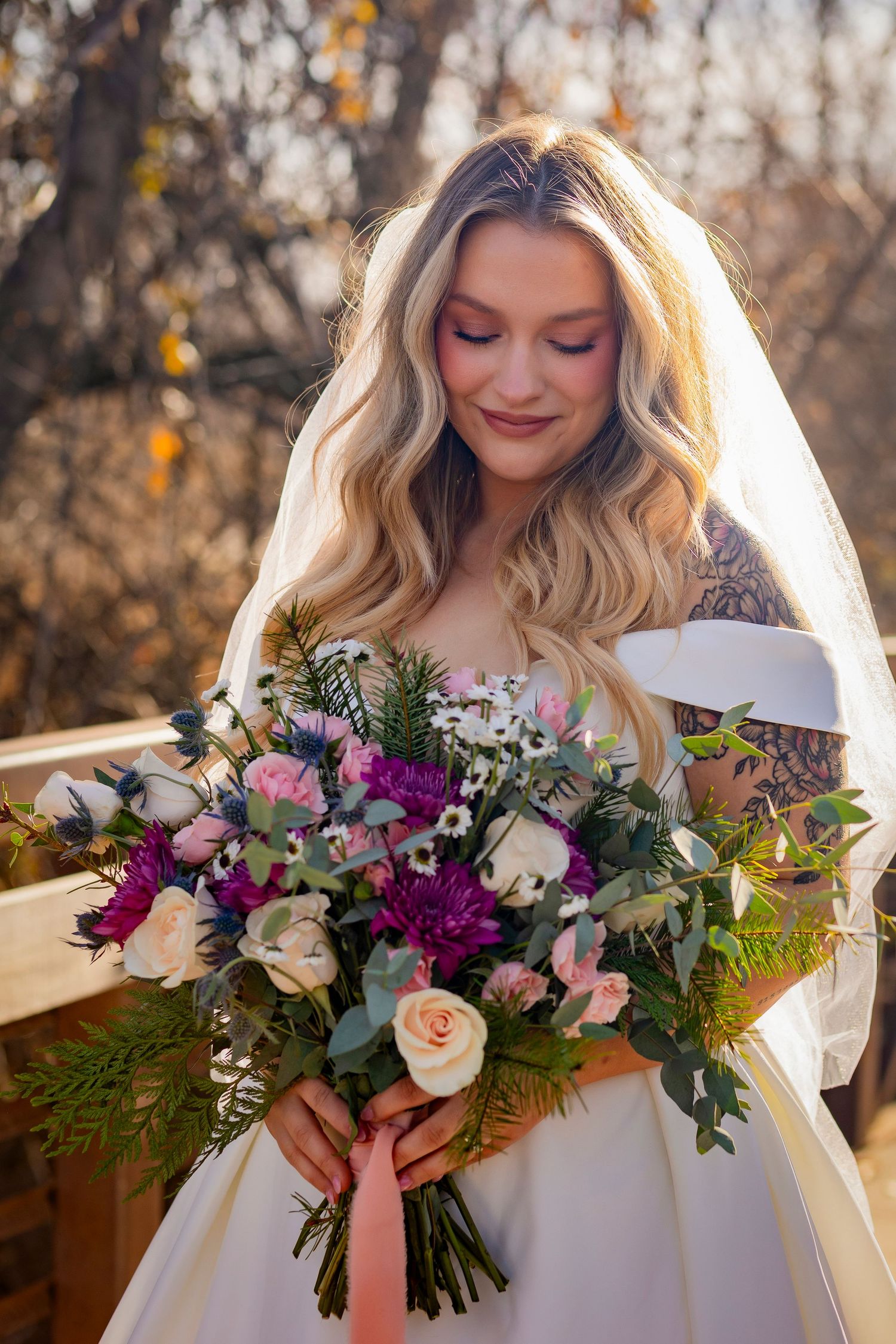 Bride looking down at bouquet