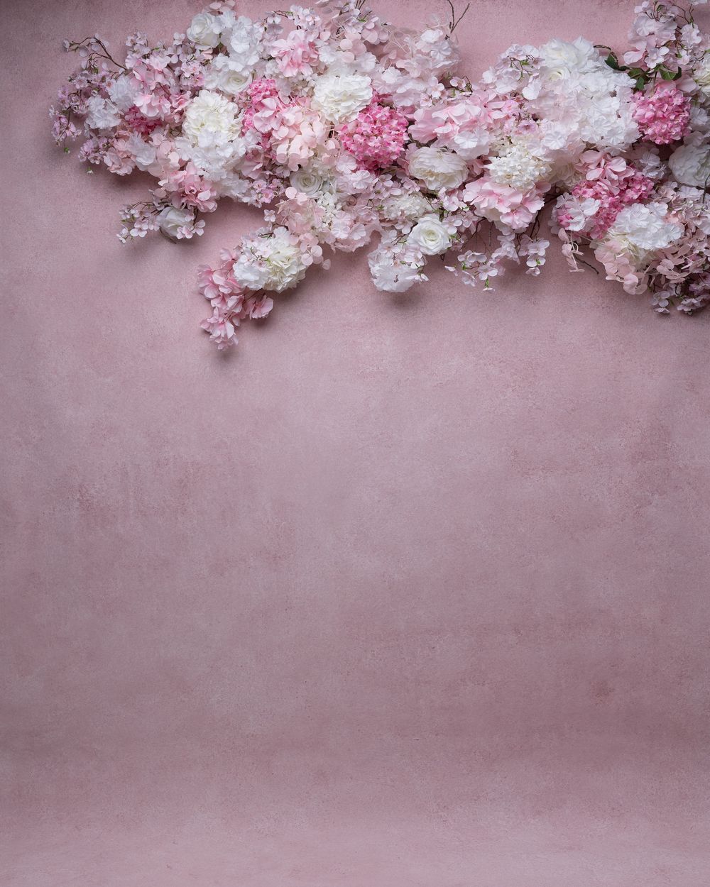 Delicate pink cherry blossoms frame the edges against a soft rosy pink background creating a romantic border design.