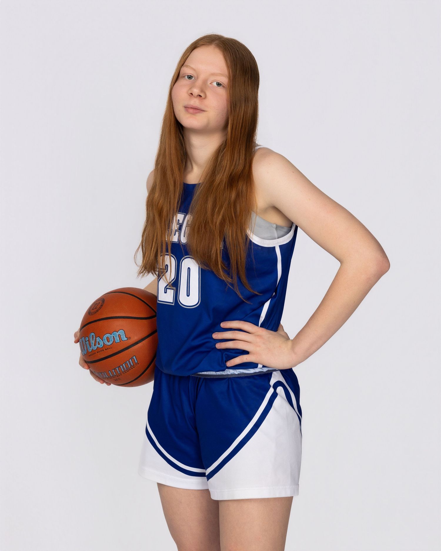 Basketball player in blue and white uniform poses in three different athletic stances holding a ball.