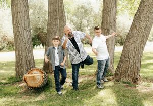 Father and 2 sons posing in slow motion for fun photo