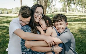 intimate moment with mom and 3 children hugging and smiling