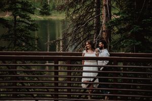 couple on bridge looking off to the side