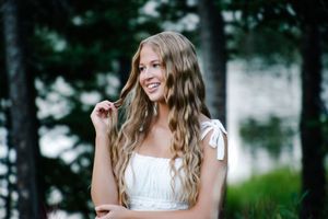 close up female smiling playing with hair