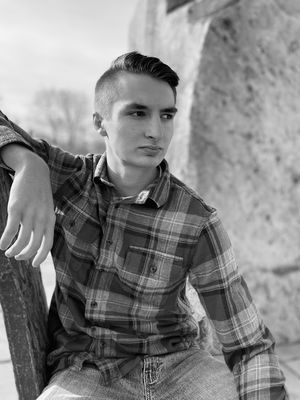 High school senior photo with rustic setting and black and white tones