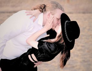 male leaning female over kissing each other