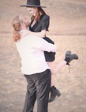 male holding female up gazing at each other