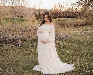 Pregnant woman holding baby bump during natural light maternity session
