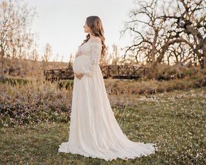 Side profile maternity photoshoot with expecting mother in flowing dress outdoors