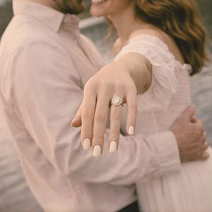 Engagement session detail shot highlighting ring and natural connection