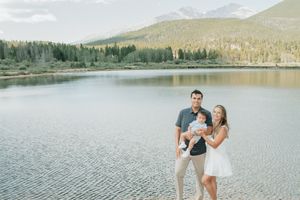 a family posing near a lake smiling