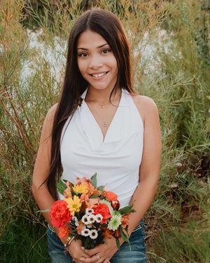 female posing holding bouquet of flowers smiling