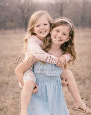 Outdoor kids photoshoot with sisters smiling and playful moment