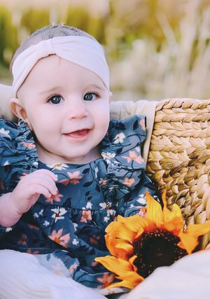 Outdoor baby photoshoot featuring cozy basket and soft neutral tones