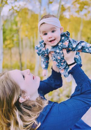 Candid mommy and me session capturing joyful moment with baby outdoors