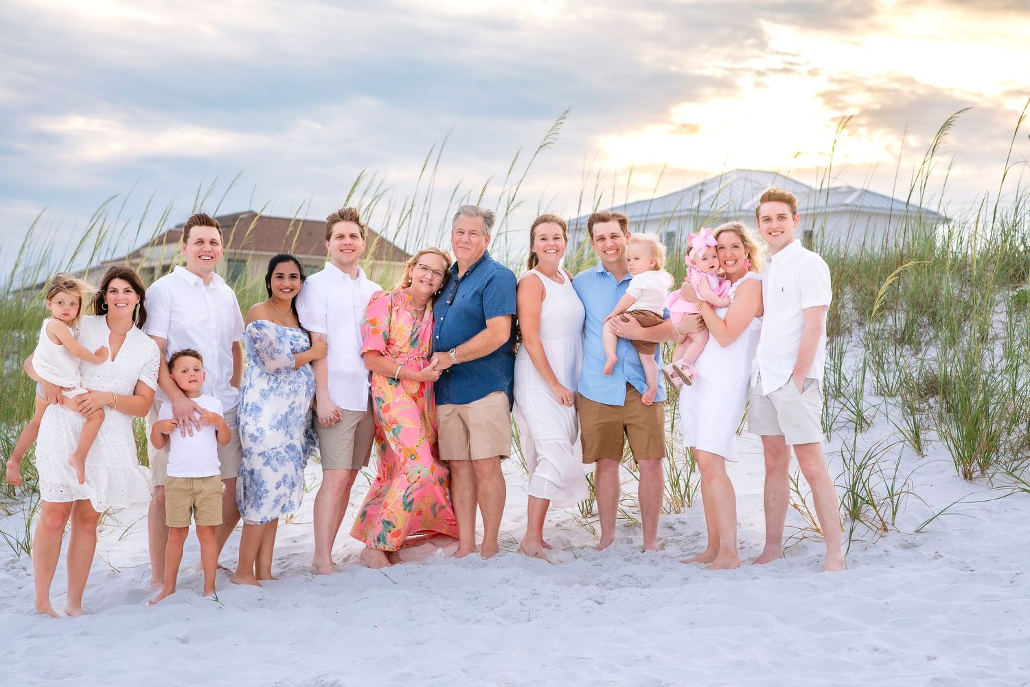 A series of family beach portraits showing groups in white and pastel clothing posing on sandy dunes at sunset.