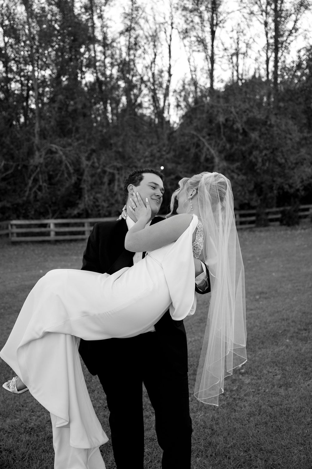 Black and white romantic dip pose during outdoor wedding photoshoot.