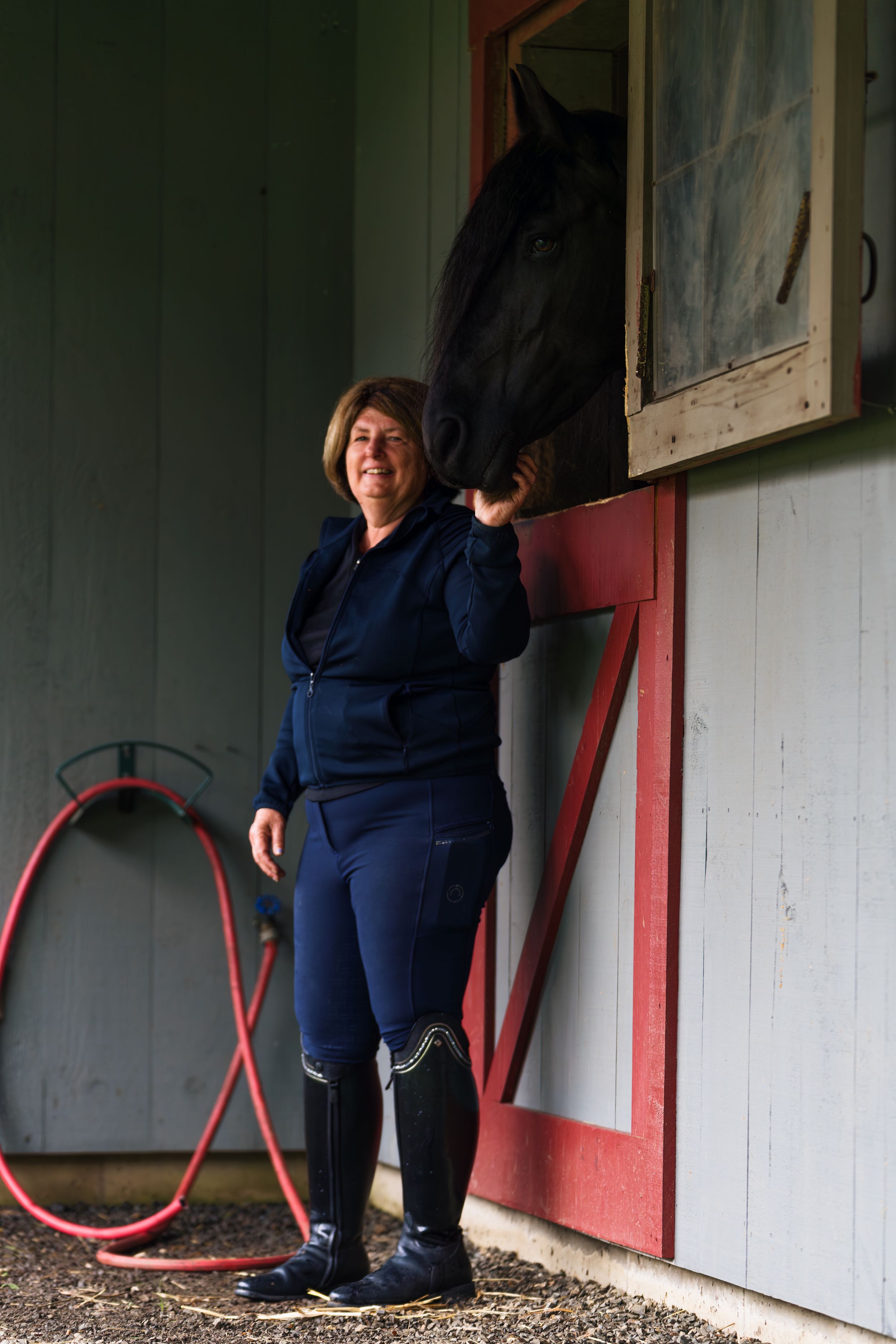 A series of four photos showing someone in navy blue clothing standing against a wall with red trim and a red hula hoop.