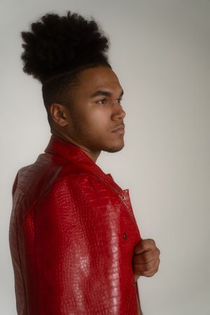 Charleston fashion studio portrait of male model in red leather jacket on white background