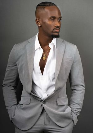 Charleston professional men’s studio portrait in light gray suit on neutral background