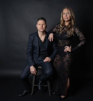 Charleston studio portrait of well-dressed couple against a dark backdrop.