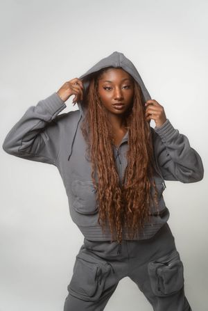 Charleston editorial studio portrait of woman wearing grey hooded set on white backdrop