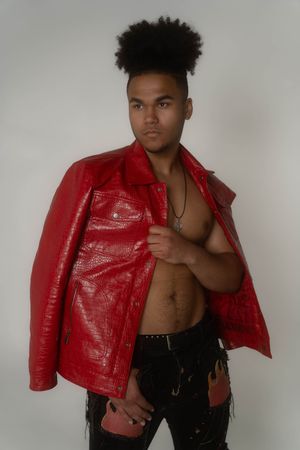 Charleston editorial men’s studio portrait of male model wearing red leather jacket