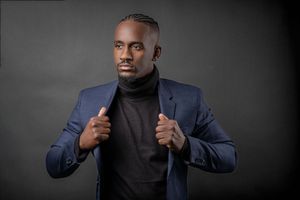 Charleston modern men’s studio portrait in navy suit with black turtleneck
