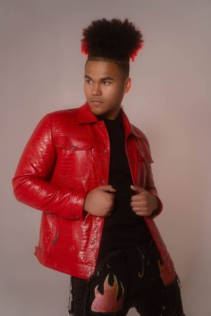 Charleston high fashion studio portrait of male model in red jacket and black jeans