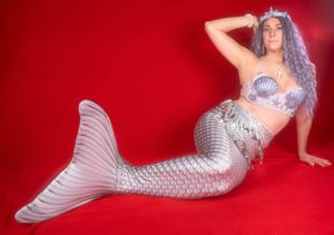 Charleston fantasy themed studio portrait featuring woman dressed as a mermaid on red backdrop.