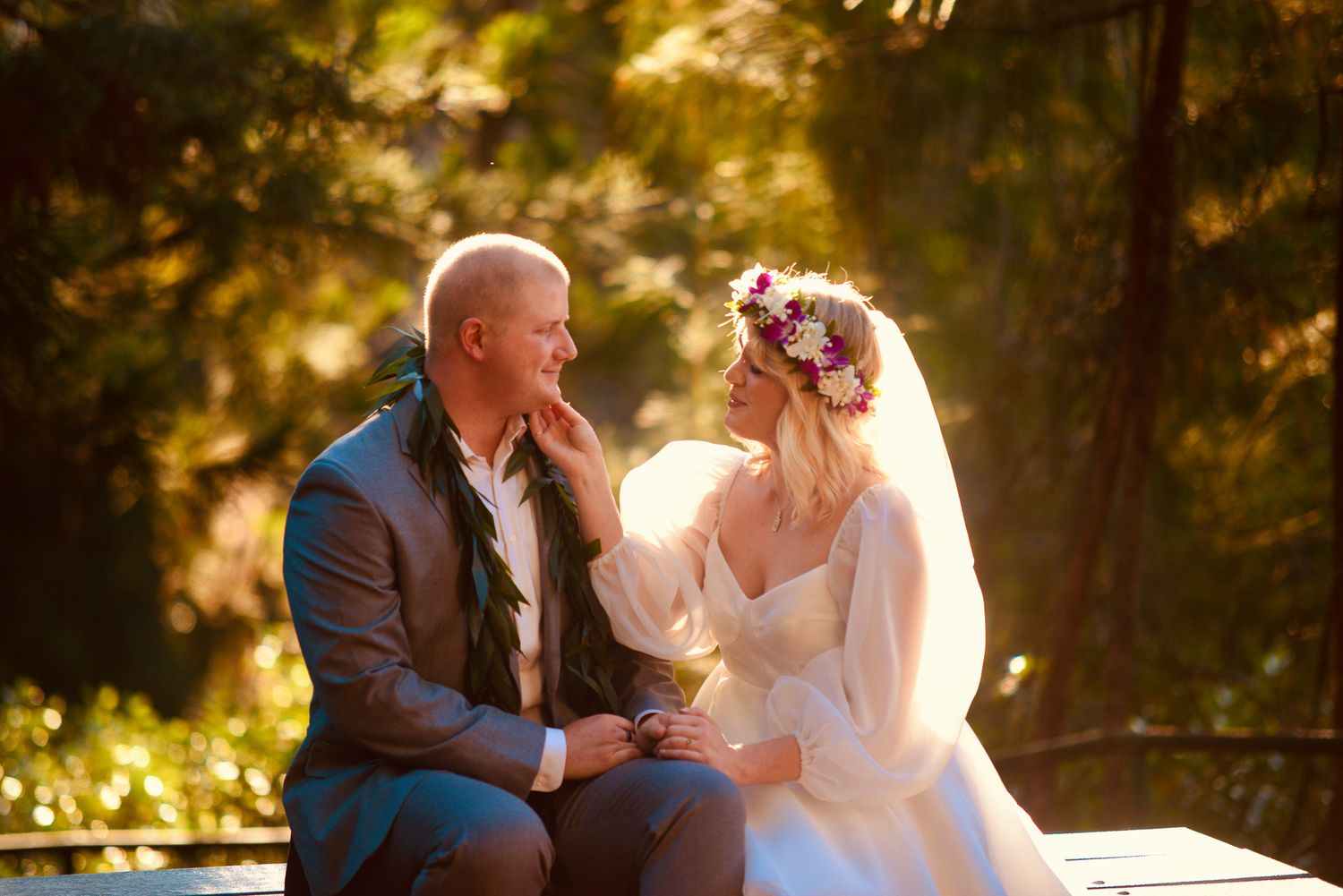 A romantic evening embrace on a porch with glowing garden lights and weeping willow trees in the background.