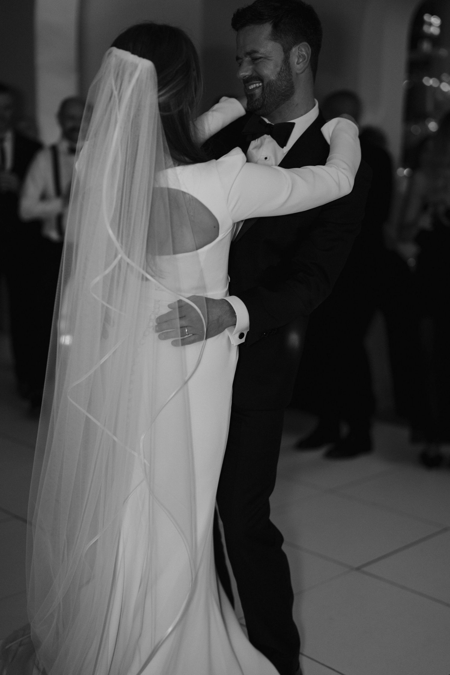 close up of grooms wedding ring on hand holding brides waist during first dance at Iscoyd park