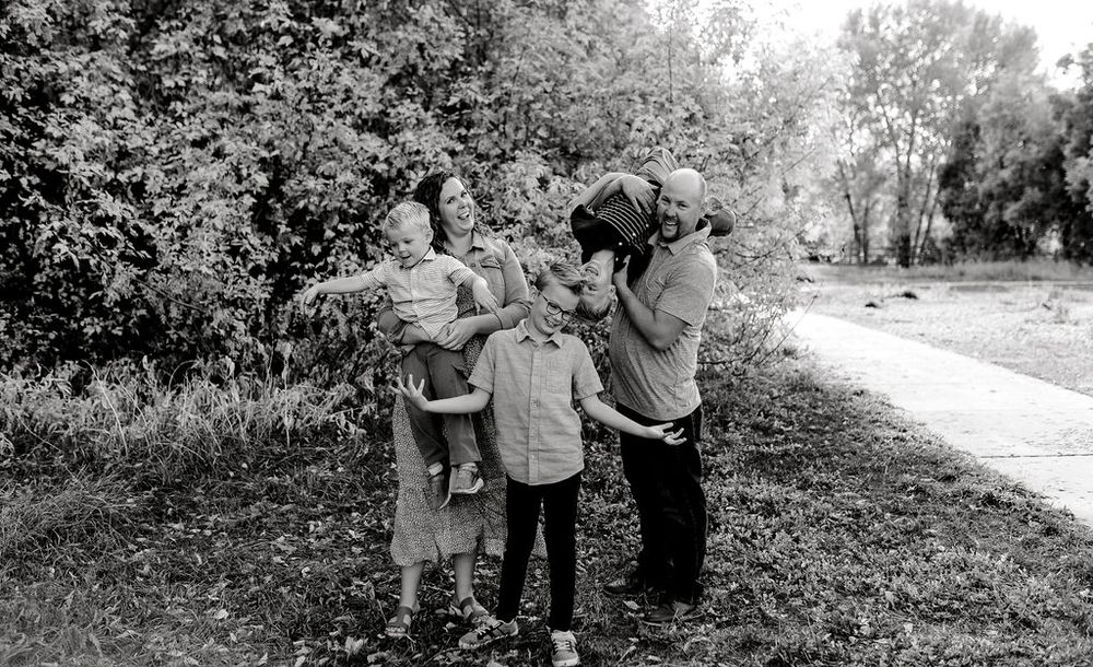 A series of black and white photographs showing people outdoors in a rural or park-like setting.