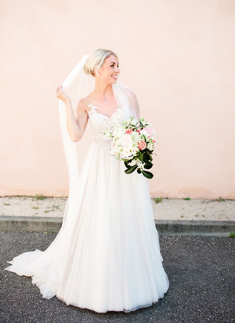 Bride holding veil and bouquet at Château de Massillan wedding in Provence