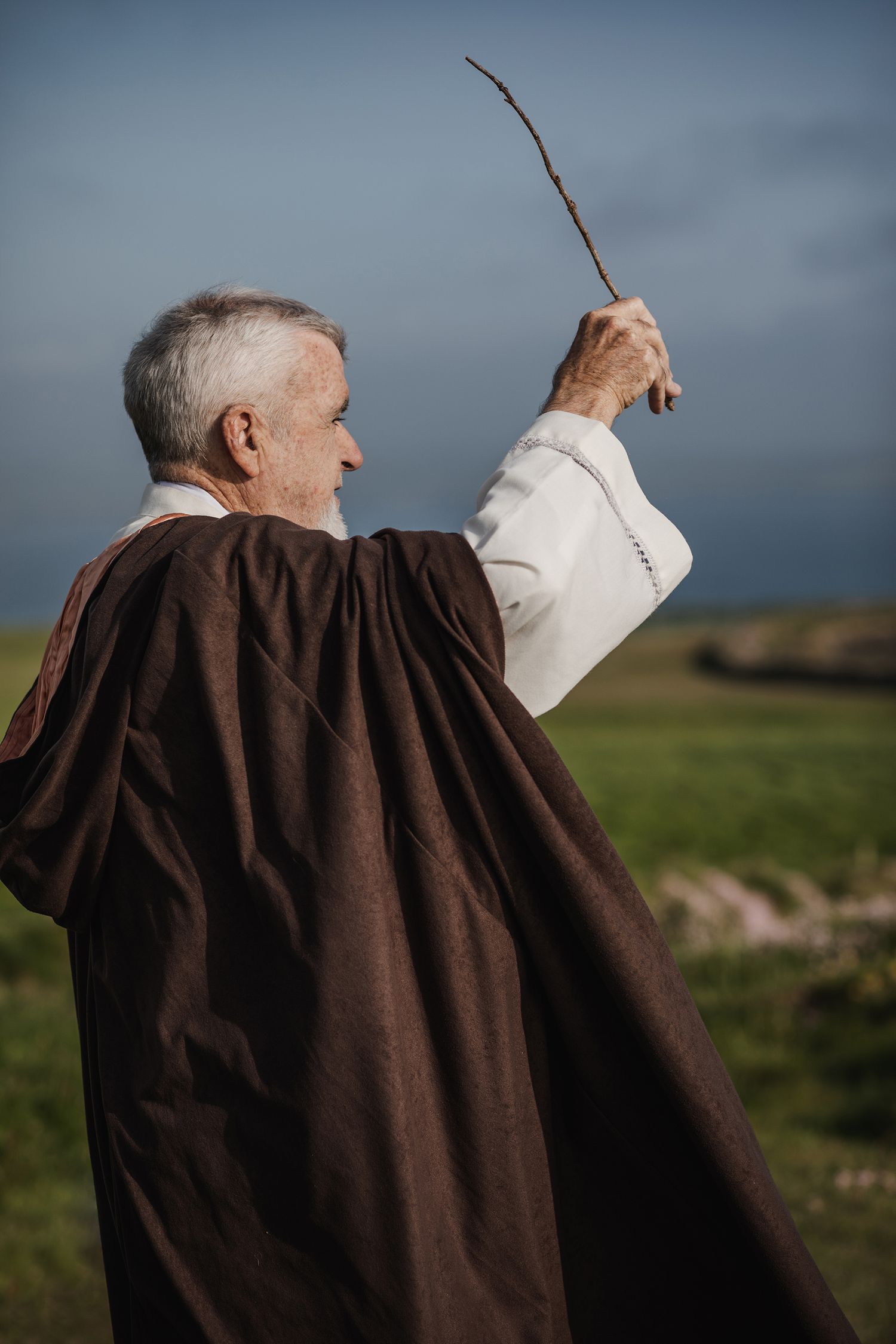 Wedding officiant performing handfasting ceremony during Ireland destination elopement