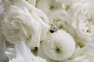 Close-up of white roses and chrysanthemums with a small bee on a flower.