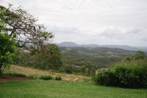 Scenic mountain landscape view with rolling hills and cloudy sky.